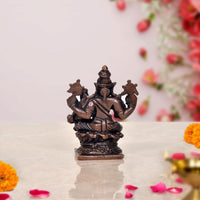 Copper Lakshmi Varaha idol, rear view with braided crown and seated posture on base