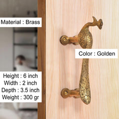 Gold brass peacock door handle on wood panel, screw-mounted bar handle