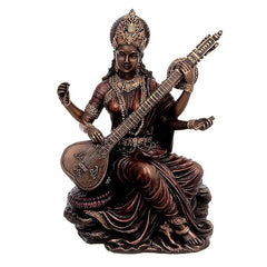Saraswati resin idol holding veena, seated with ornate crown and jewelry