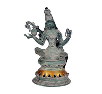 Saraswati brass statue seated with veena, raised arms and crown, dark green patina finish
