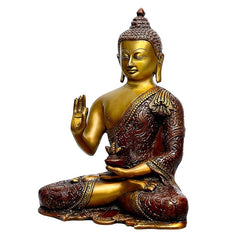 Seated brass Buddha idol with blessing hand raised, gold body, detailed patterned robe