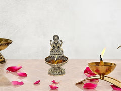 Brass Lakshmi diya oil lamp figurine with lit flame, ornate circular holder (4 in)