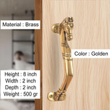 Golden brass horse head door handle on light wood door, with curved lever