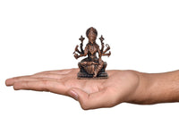 Copper Varahi eight-armed sculpture held in hand for scale, seated on pedestal, 3 in