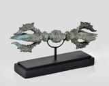 Bronze eight-pronged Dorje on black wooden base, turquoise patina, side angle