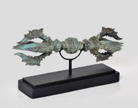 Bronze eight-pronged Dorje on black wooden base, turquoise patina, side angle