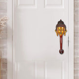 Buddha-face door handle with gold face details and red-brown stem