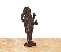 Brown brass Dhanvantri statue (6 inches), angled view, crowned head with lifted hands