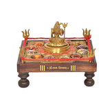Brass Shiva figurine centered on chowki with multiple circular gemstone-like inlays