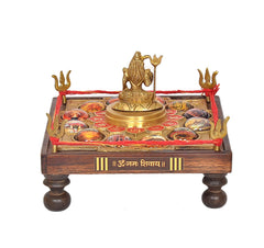 Brass Shiva figurine centered on chowki with multiple circular gemstone-like inlays