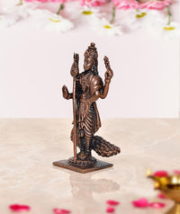 Copper standing deity murti holding staff and trident, peacock beside feet, on base