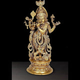 Krishna flute-playing idol, multi-plated golden finish, ornate pedestal base.