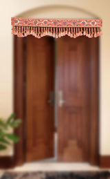 Pink toran door hanging with bead-like trim and rows of orange and gold tassels