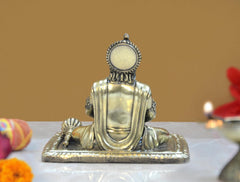 Back of brass Hanuman idol, meditating pose with circular halo on crown