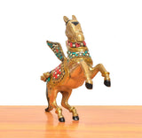 Brass winged flying horse statue, rear view with multicolor saddle and gold hooves