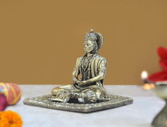 Brass Hanuman idol, seated meditation with raised crown; side angle view of statue