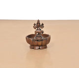 Krishna urli bowl showpiece rear view, copper basin with deity figurine on stem