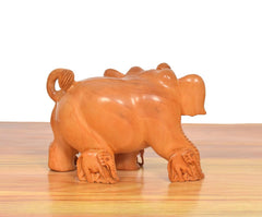 Wooden elephant showpiece from side-back, brown carved body and tail detail