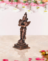 Copper Garuda idol statue side view, tall crown and folded hands with wing details
