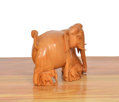 Wooden elephant showpiece with baby elephant figures, right side view