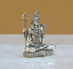 Brass Shiva sitting statue with four arms, holding trident and damaru, 2 inch