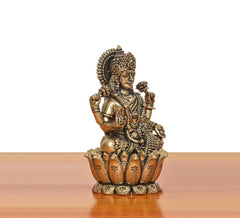 Bronze Lakshmi goddess idol, seated on lotus base, profile view with detailed ornaments