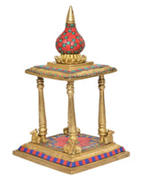 Gold brass pooja mandir with red mosaic floor and blue-red striped edge trim