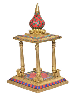 Gold brass pooja mandir with red mosaic floor and blue-red striped edge trim