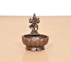 Krishna urli bowl showpiece front view, round basin with deity figurine on top pedestal