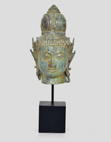 Bronze Vishnu head idol from rear angle, ornate helmet details, on black display base