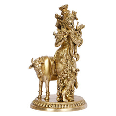 Brass Krishna riding cow figurine, side view with detailed jewelry and crown