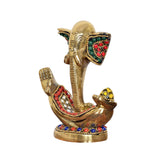 Brass Ganesha idol close-up, jeweled ears and raised blessing hands