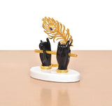 Black Krishna hands holding flute with gold peacock hood, white round stand