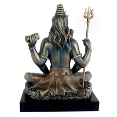 Back view of Lord Shiva bronze tone statue seated with long hair and raised trident
