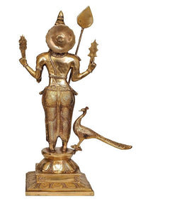 Brass Lord Kartikeya figurine holding spear and staff, peacock beside, 23.5 in