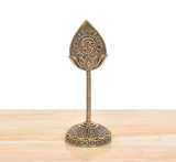 Bronze Lord Karttikeya Murugan vel on round base; ornate leaf-and-emblem top