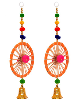 Pair of toran latkans: orange-and-white wheel design with bright pink center, bead garlands, gold bell