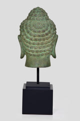 Back view bronze Buddha head idol on black stand, ornate hair and neck