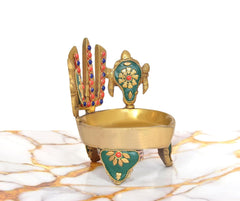 Brass oil lamp with teal corner panel, chakra back symbol, and small flame-bowl top