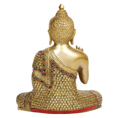 Brass Buddha statue back view; red and blue inlay on robe; seated meditation