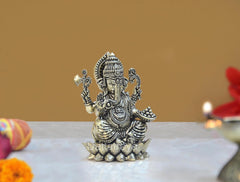 Brass Lord Ganesha idol on lotus, side view with one hand raised, 3 in tall