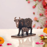 Copper cow statue with calf, rear three-quarter view, carved saddle and patterned armor