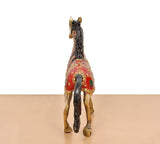 Brass running horse showpiece rear view, red coat with painted motifs and gold legs