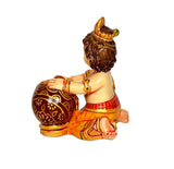 Resin Laddu Gopal idol, other side view showing crown, draped cloth, and butter pot.