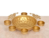 Gold peacock-style decorative urli bowl with six tea light candle holders