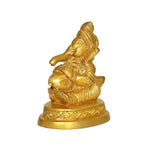Gold Ganesha statue with raised arm pose, ornate pedestal base