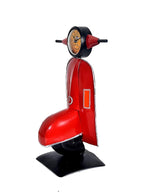 Side view: red scooter table topper with clock wheel on top and black base