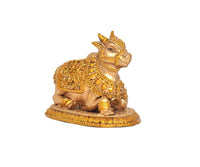 Seated Nandi bull idol showing head and shoulder jewelry, gold accents on base