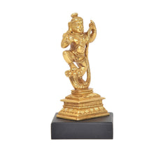 Dancing Bal Krishna brass statue with raised right arm, detailed ornaments, black base