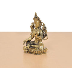 Tara Devi deity statue in brass finish, three-quarter side view with raised hand